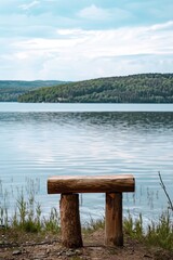 A wooden table standing out on a calm lake background.