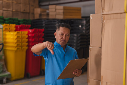 An inspector or auditor giving a thumbs down gesture. Highlighting poor and shoddy product quality or bad inventory management at a warehouse.