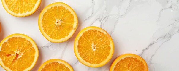 Fototapeta premium Freshly cut orange slices on white marble background.