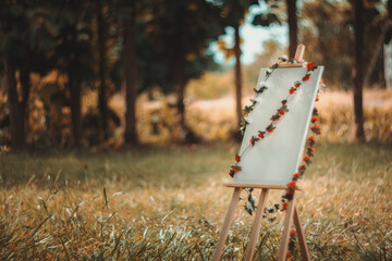 A white easel with a red and white string hanging from it