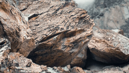 Fototapeta premium An Alpine big Rocky Mountain stone with a stone texture and blurred background in Gilgit-Baltistan, Pakistan.