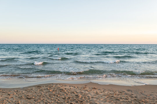 Red flag warning at the sea with high tide waves as signal for danger and hazard rip current activity in Thailand.