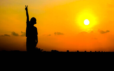 A boy and the atmosphere of the evening sky.