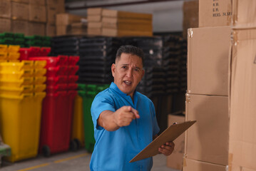 A supervisor scolding an unseen employee during an inspection inside the warehouse. Criticizing...