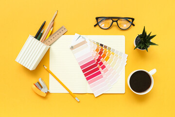 Composition with notepad, coffee, eyeglasses and color palettes on yellow background