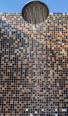 beach shower on the background of a mosaic wall