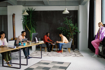 Creative loft office room atmosphere. Workers group together