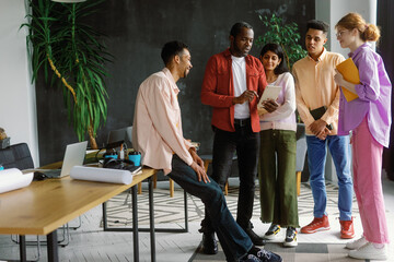 Creative office employees having break. Standing together