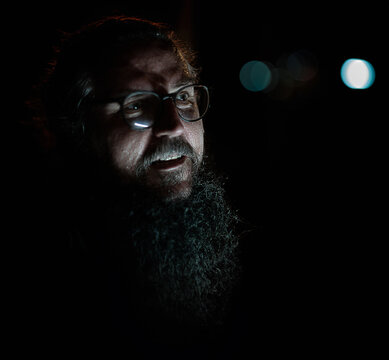 Middle age man with long beard in night