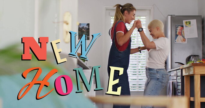 Image of new home text over gay lesbian couple dancing at home - Powered by Adobe