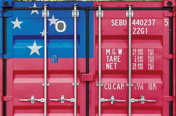 Samoa flag depicted on metal doors of shipping cargo container outdoors in docks area close up