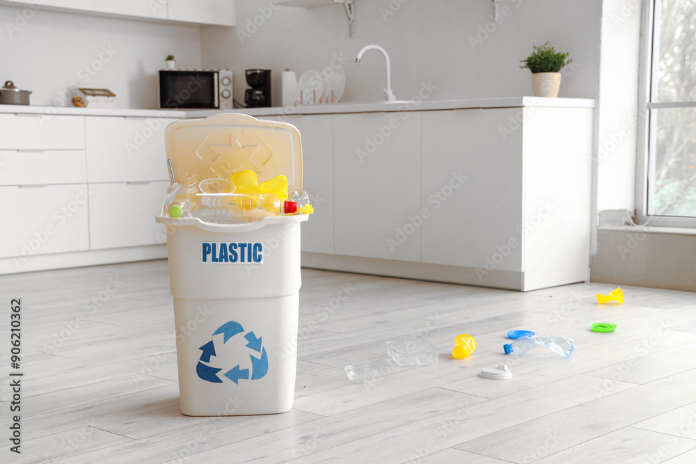 Poster full trash bin with plastic sign and garbage on floor in kitchen. recycling concept