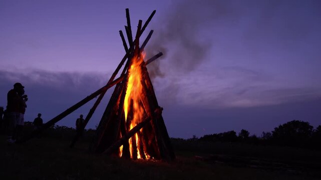 Beautiful bonfire on meadow on August 1st national holiday of Switzerland at Swiss City of Z&uuml;rich on a summer night. Movie shot August 1st, 2024, Zurich, Switzerland.