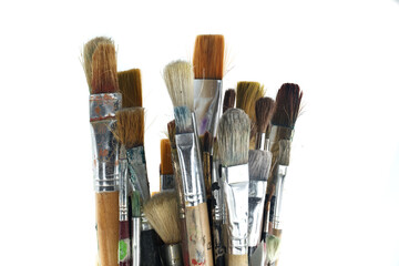 Paintbrushes varying sizes and bristle styles with wooden handles
