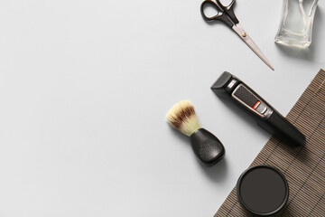 Set of male shaving accessories on light grey background