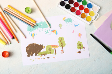 Children's drawing with notebooks, watercolor paints and colorful pencils on light blue background
