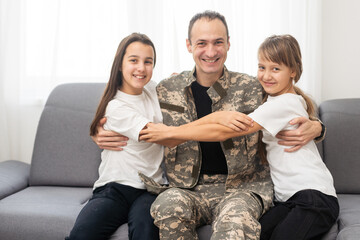 military father and two daughters at home
