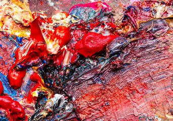 Multi-colored oil paints on the artist's table. Abstract background