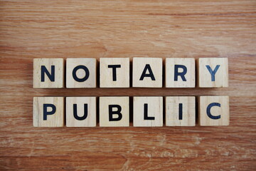 Notary Public alphabet letters top view on wooden background, business and law concept