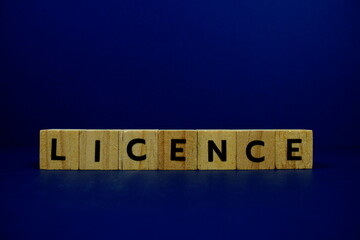 Licence with wooden blocks alphabet letters on blue background