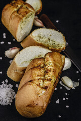 Sliced ​​bread with garlic on black background