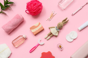 Composition with cosmetic products, bath accessories and toy for baby on pink background
