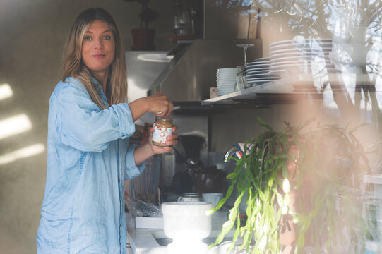 Healthy Kitchen - woman prepares healthy food in her summer kitchen