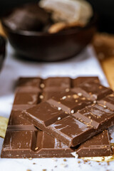 Chocolate chip cookies, dark and white chocolate bar, small bowl of oatmeal and nuts. International Chocolate Day.