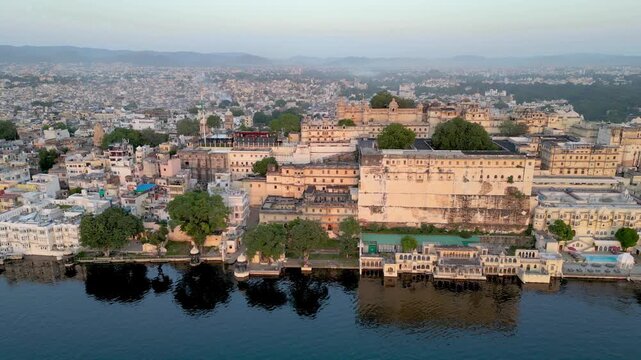 Aerial view of Udaipur city during sunset, known for its beautiful lakes, palaces, and historical significance. The city was founded in 1559.