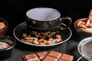 Chocolate chip cookies, dark and white chocolate bar, small bowl of oatmeal and nuts. International Chocolate Day.