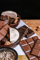 Chocolate chip cookies, dark and white chocolate bar, small bowl of oatmeal and nuts. International Chocolate Day.