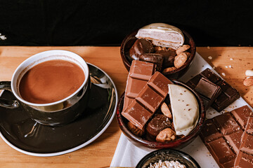Chocolate chip cookies, dark and white chocolate bar, small bowl of oatmeal and nuts. International Chocolate Day.