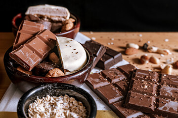 Chocolate chip cookies, dark and white chocolate bar, small bowl of oatmeal and nuts. International Chocolate Day.