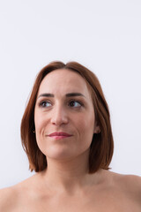 Close-up portrait of 30 years old smiling pretty woman with short red hair looking to the side isolated on white background. Natural beauty concept