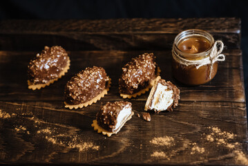 Mini dessert in a modern version. Portion cheesecake covered with chocolate and nuts. Fashionable French chocolate cake.