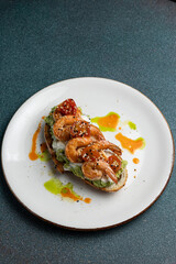 Delicious bruschetta with shrimp, cheese and herbs