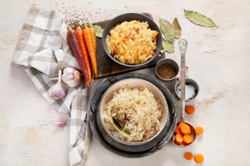 Winter salad on wooden light background. Homemade sauerkraut cabbage withcarrot. Tasty