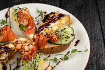 different types of bruschetta. With salmon, meat, soft cheese, herbs