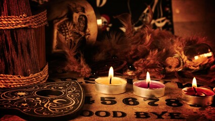 Creepy Skull on a Witchcraft Ouija Board and Candles