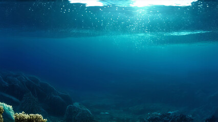 Underwater view with bubbles rising to the surface in a deep blue ocean.