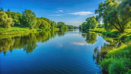 Obraz premium Serene river view with a lush green riverbank and a clear blue sky, river, view, landscape, nature, serene, peaceful