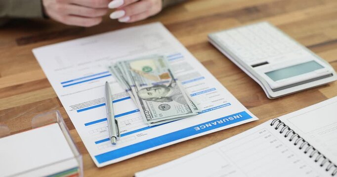 Client places insurance form and dollars on table