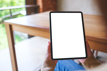 Mockup image of a woman holding digital tablet with blank white desktop screen