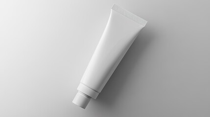 Minimalistic blank cosmetic tube on a light gray background, ideal for branding and promotional design purposes.