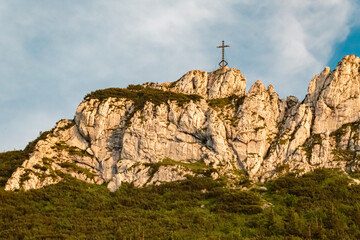 Alpine summer evening view with a summit cross at Mount Kampenwand, Aschau, Chiemgau, Rosenheim, Bavaria, Germany
