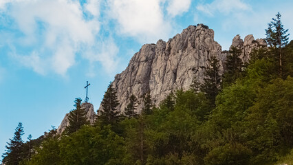 Alpine summer evening view with a summit cross at Mount Kampenwand, Aschau, Chiemgau, Rosenheim, Bavaria, Germany
