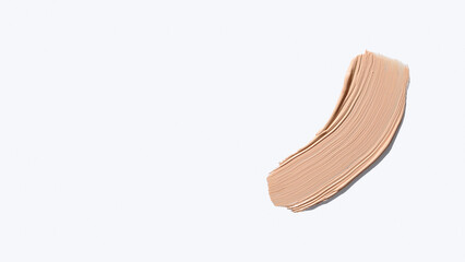 Liquid foundation smudge on white background. Beauty skincare texture swipe swatch. Cosmetic makeup cream sample isolated on white