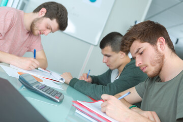 students usinga calculator in office table