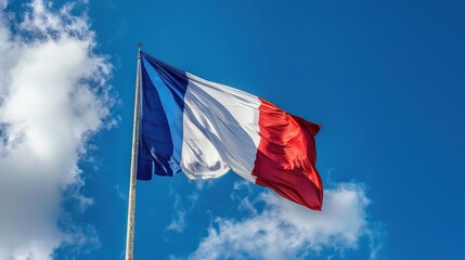 Fototapeta premium The French national flag (Tricolore) waving in the wind. The flag consists of three vertical stripes: blue on the hoist side, white in the middle, and red on the fly side. The background should