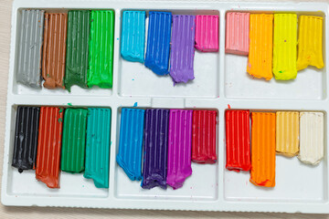 Colorful plastilin background. Pieces of multicolor plasticine modeling clay, close-up